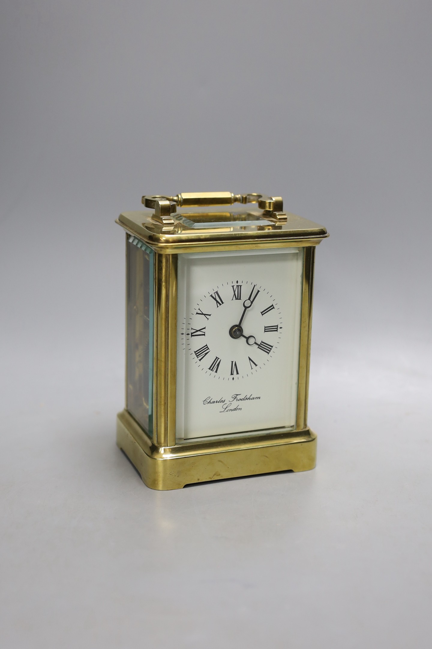 A large brass carriage clock, retail by Charles Frodsham, 14.5 cms high.